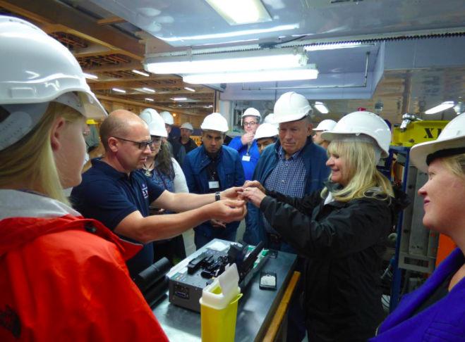 Gov. Bill Walker and First Lady Donna Walker inspect the cable that is being laid under the sea from Asia to Europe, across the top of Alaska. 