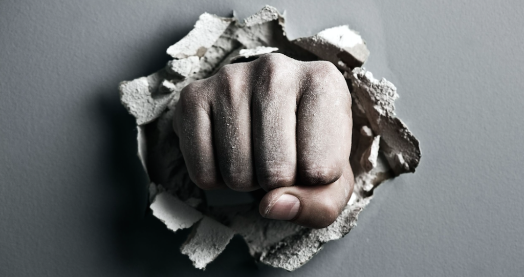 Tough: Photo of fist through wall.