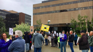Citizens gather outside the Boney Courthouse in Anchorage on June 21 to protest the governor's veto of half of last year's Permanent Fund dividend.