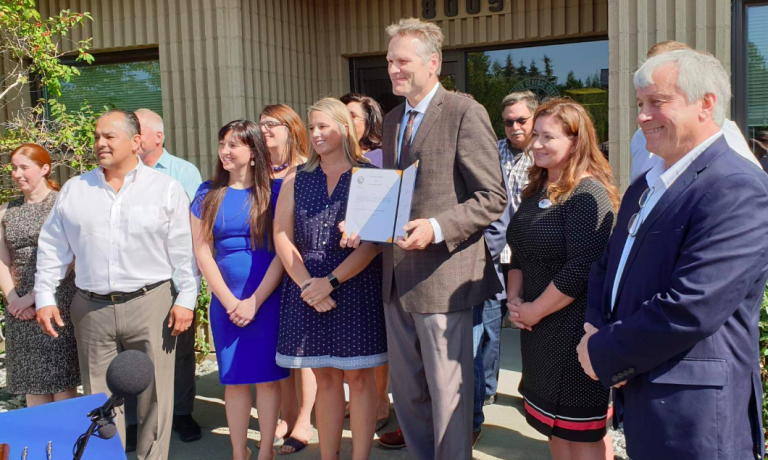 Capital budget signed in event tempered by senator’s passing