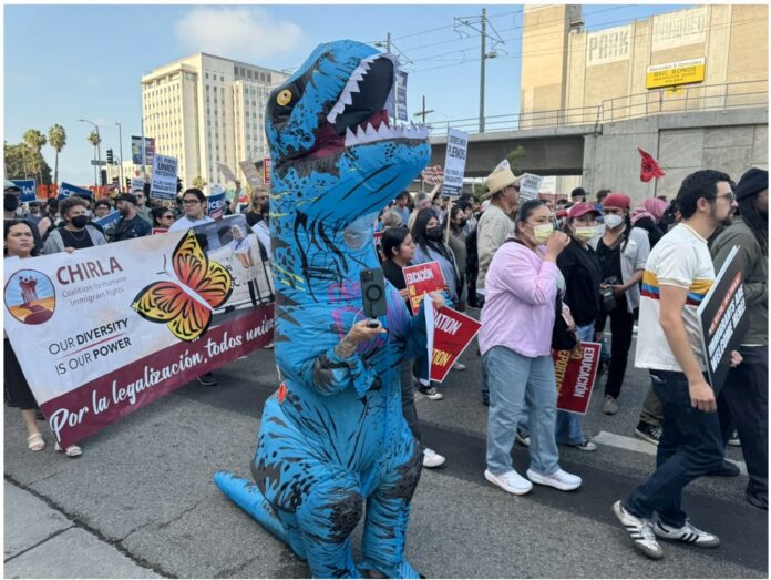 Demonstrators bearing a sign for the Coalition for Humane Immigrant Rights march in downtown Los Angeles on June 6, 2025 in response to federal immigration enforcement operations. Photo: Anthony Cabassa.
